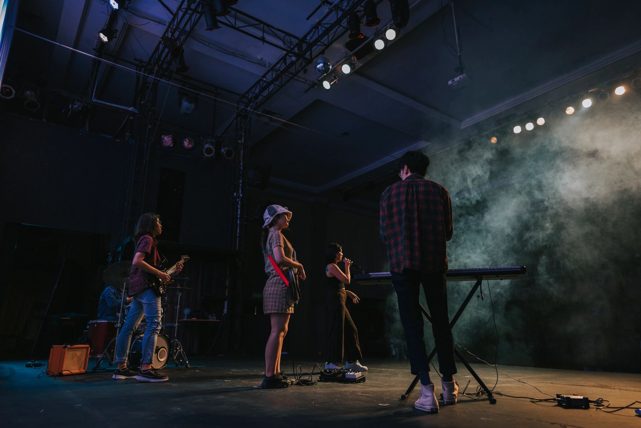 Live band performing on stage with bright lights