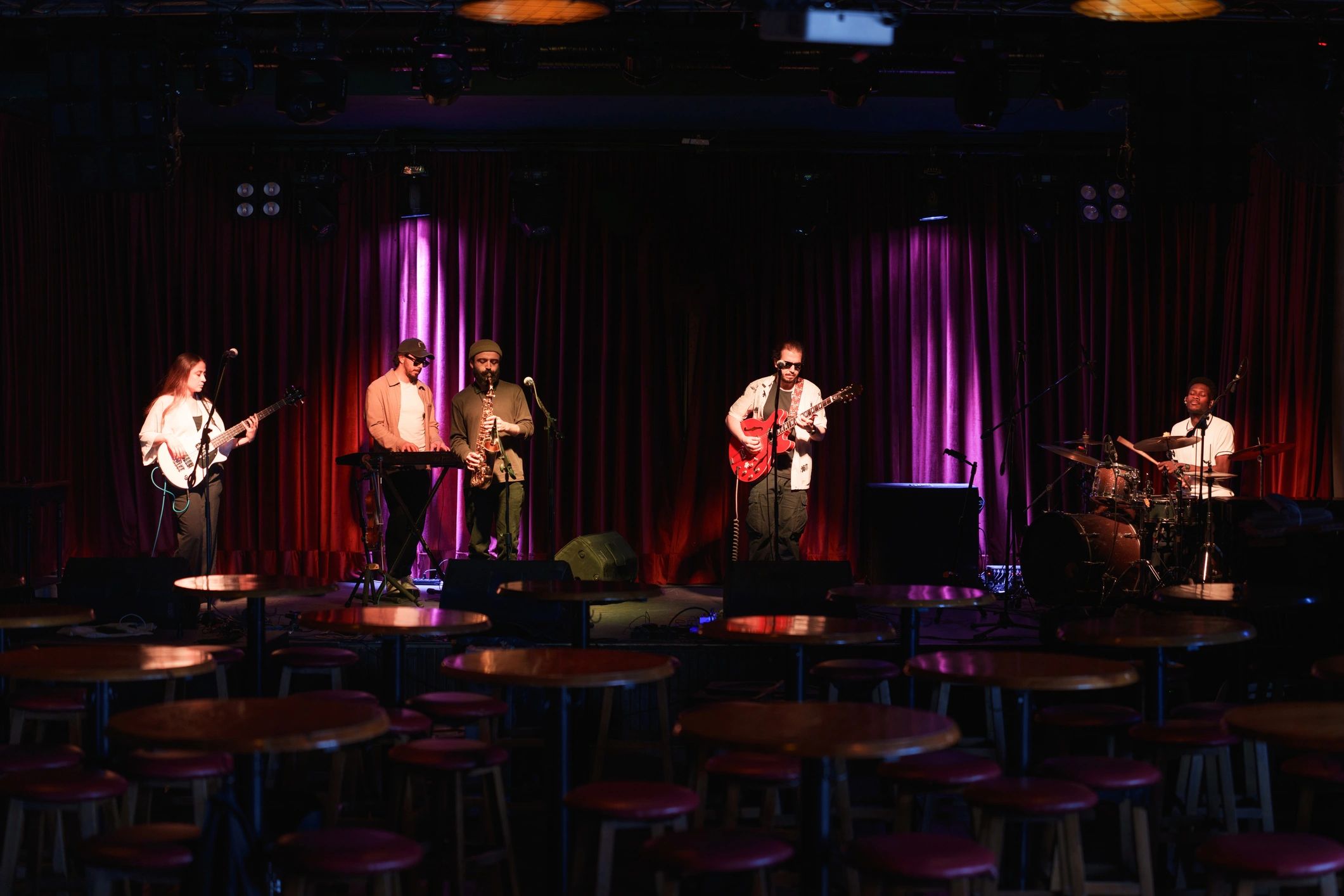 Band performing live on stage in a dark music venue